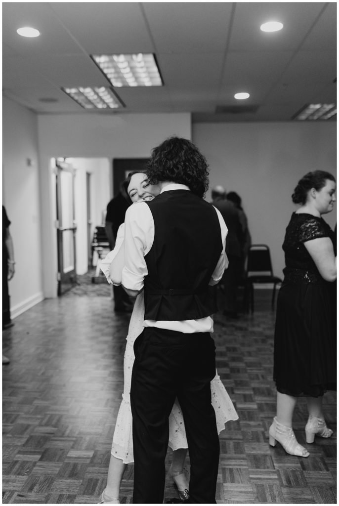 bride and groom dance at their wedding in black and white